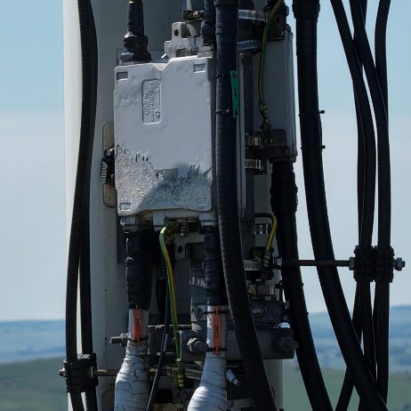 Close-up of electrical connections and equipment mounted on a telecoms mast.