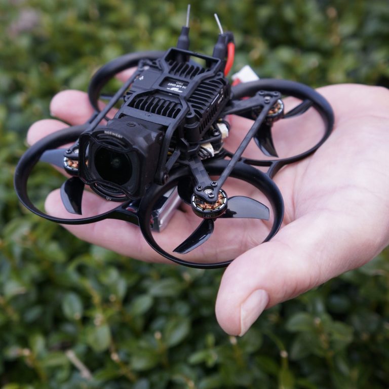A tiny drone held in a hand.